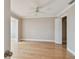 Bright bedroom featuring hardwood floors, neutral paint, and a ceiling fan at 2421 Lake Point Ln, Clearwater, FL 33762