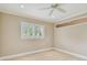 Cozy bedroom featuring a ceiling fan and bright shuttered window at 2421 Lake Point Ln, Clearwater, FL 33762