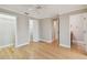 Primary bedroom featuring hardwood floors, neutral paint, and multiple closets at 2421 Lake Point Ln, Clearwater, FL 33762