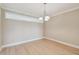 Bright dining room with light wood floors and a decorative chandelier at 2421 Lake Point Ln, Clearwater, FL 33762