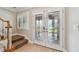 Inviting foyer with stylish glass doors and a view of the staircase at 2421 Lake Point Ln, Clearwater, FL 33762