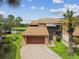 Charming villa with a beautiful golf course view, two car garage, and brick paver driveway at 2421 Lake Point Ln, Clearwater, FL 33762