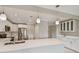 Open kitchen design boasts white cabinets, quartz countertops, and stainless steel appliances at 2421 Lake Point Ln, Clearwater, FL 33762