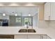 Bright kitchen with a view showcases quartz counters, stainless appliances, and modern white cabinets at 2421 Lake Point Ln, Clearwater, FL 33762