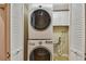Laundry area with stacked washer/dryer and cabinets at 2421 Lake Point Ln, Clearwater, FL 33762