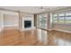 Spacious living room with fireplace, hardwood floors, large windows and sliding glass doors to patio at 2421 Lake Point Ln, Clearwater, FL 33762