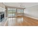 Bright living area features wood flooring, white trim, fireplace, and access to an outdoor patio at 2421 Lake Point Ln, Clearwater, FL 33762