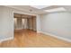Open living room with hardwood floors, natural light from skylights, and an open entrance to an adjoining room at 2421 Lake Point Ln, Clearwater, FL 33762