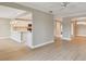 Open-concept area features light wood flooring, access to the kitchen, and views to other living spaces at 2421 Lake Point Ln, Clearwater, FL 33762