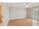 Bright main bedroom with ceiling fan, hardwood floors and sliding doors to the patio at 2421 Lake Point Ln, Clearwater, FL 33762
