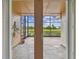 Covered and screened patio has tiled floor and a view of the pond and landscaping at 2421 Lake Point Ln, Clearwater, FL 33762