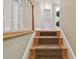 Carpeted steps lead to a second level with a linen closet and access to multiple bedrooms at 2421 Lake Point Ln, Clearwater, FL 33762