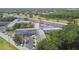 Expansive aerial view of a light-colored condo complex surrounded by trees, lawns and parking lots at 2469 Franciscan Dr # 59, Clearwater, FL 33763