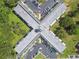 Overhead view of multi-building condo shows the x-shaped layout of each structure in its verdant setting at 2469 Franciscan Dr # 59, Clearwater, FL 33763