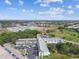 Stunning aerial view of the property's building and surrounding landscaping, trees, and parking lot on a bright sunny day at 2469 Franciscan Dr # 59, Clearwater, FL 33763