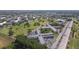 Wide aerial shot of a sprawling light-colored condo complex adjacent to green spaces and parking areas at 2469 Franciscan Dr # 59, Clearwater, FL 33763