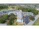 Aerial view of condo with adjacent parking lots, lush landscaping, and an attractive tower at 2469 Franciscan Dr # 59, Clearwater, FL 33763