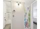 Hallway leading to a newly renovated bathroom with tiled walls at 2469 Franciscan Dr # 59, Clearwater, FL 33763