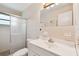 Bathroom showing tiled walls, mirrored vanity, and shower with glass door at 2469 Franciscan Dr # 59, Clearwater, FL 33763