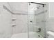 Bright bathroom featuring tiled walls, updated shower with glass doors, and modern fixtures at 2469 Franciscan Dr # 59, Clearwater, FL 33763