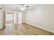 Spacious bedroom with hardwood flooring, ceiling fan, and a view to the enclosed patio at 2469 Franciscan Dr # 59, Clearwater, FL 33763