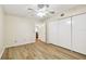 Bedroom featuring wood-look floors, a ceiling fan, and closet doors at 2469 Franciscan Dr # 59, Clearwater, FL 33763