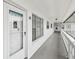 Entrance to unit 59 with a white door, secure access, and a well-lit walkway at 2469 Franciscan Dr # 59, Clearwater, FL 33763