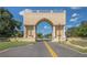 Dramatic arched entrance with columns, statues, and a distant view of a globe on a sunny day with a clear blue sky at 2469 Franciscan Dr # 59, Clearwater, FL 33763