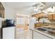 Bright kitchen with a white refrigerator and wooden cabinets at 2469 Franciscan Dr # 59, Clearwater, FL 33763