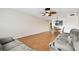 Comfortable living room features wood flooring and a ceiling fan at 2469 Franciscan Dr # 59, Clearwater, FL 33763