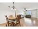 Open concept living and dining area with wood flooring and ceiling fan at 2469 Franciscan Dr # 59, Clearwater, FL 33763