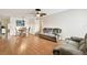 Cozy living room with wood floors, ceiling fan, and dining area with comfortable seating at 2469 Franciscan Dr # 59, Clearwater, FL 33763