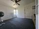 A cozy bedroom featuring natural light, a ceiling fan, and an entry door at 2510 Queen S St, St Petersburg, FL 33712