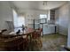 Eat-in kitchen features vintage flooring, a small refrigerator, and bright natural light at 2510 Queen S St, St Petersburg, FL 33712