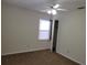 Bright bedroom features a ceiling fan, plush carpet, closet, and window offering natural light at 2701 47Th N Ave, St Petersburg, FL 33714