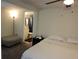 A bedroom featuring a connected bathroom and a comfy ottoman at 2701 47Th N Ave, St Petersburg, FL 33714