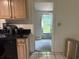 Kitchen featuring wood cabinets, black countertops, and tile flooring with backyard access at 2701 47Th N Ave, St Petersburg, FL 33714