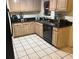 A view of the kitchen featuring wood cabinets, dark countertop and tiled floor at 2701 47Th N Ave, St Petersburg, FL 33714