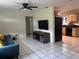 Bright living room featuring tile flooring, a ceiling fan, and a view into the kitchen at 2701 47Th N Ave, St Petersburg, FL 33714