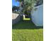 Fenced side yard featuring lush grass and mature trees for privacy, offering potential for outdoor activities or gardening at 2701 47Th N Ave, St Petersburg, FL 33714
