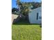 The well-maintained side yard is enhanced by tropical palm trees and a sturdy wooden fence, blending nature and privacy at 2701 47Th N Ave, St Petersburg, FL 33714