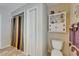 Bright bathroom with a decorative cabinet, toilet, and tub with unique, colorful striped shower curtain at 2811 Barret Ave, Plant City, FL 33566
