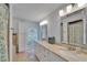 Bathroom with double sinks, large mirrors, and a window providing natural light at 2811 Barret Ave, Plant City, FL 33566