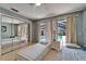 Bedroom featuring sliding glass doors to the screened pool area, mirrored closet doors, and neutral walls at 2811 Barret Ave, Plant City, FL 33566
