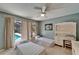 Bright bedroom with twin beds, a ceiling fan, and a sliding glass door leading to the pool area at 2811 Barret Ave, Plant City, FL 33566