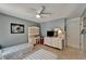 Cozy bedroom featuring two twin beds, a ceiling fan, and ample storage and workspace at 2811 Barret Ave, Plant City, FL 33566