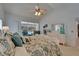 Bright bedroom features a bed with patterned bedding, pool view, and a sitting area at 2811 Barret Ave, Plant City, FL 33566