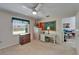 Spacious bedroom with ceiling fan, desk, and ample natural light from the window at 2811 Barret Ave, Plant City, FL 33566