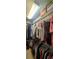 Spacious closet with ample hanging storage and overhead shelving, illuminated by a fluorescent light fixture at 2811 Barret Ave, Plant City, FL 33566