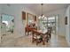 Bright dining area with a wooden table and chairs, adjacent to the patio and a glimpse of the bedroom at 2811 Barret Ave, Plant City, FL 33566